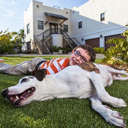 A five year old enjoys time with his best friend.
