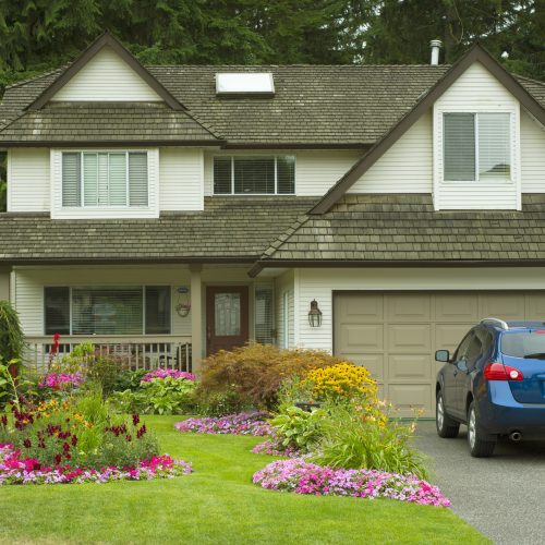 A beautiful Home and manicured yard with a garden full of perennials and annuals.